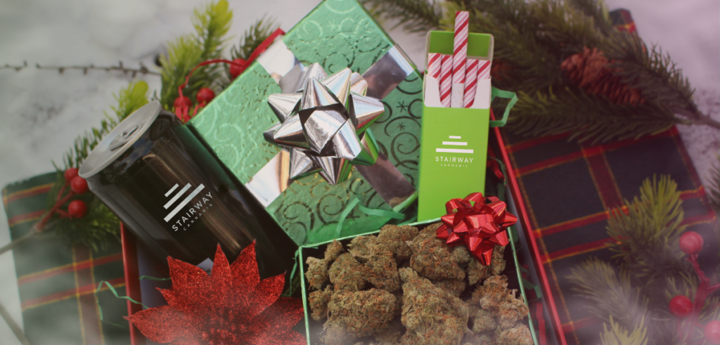 A THC-infused beverage, pre-rolls, and cannabis flower nugs in gift boxes.