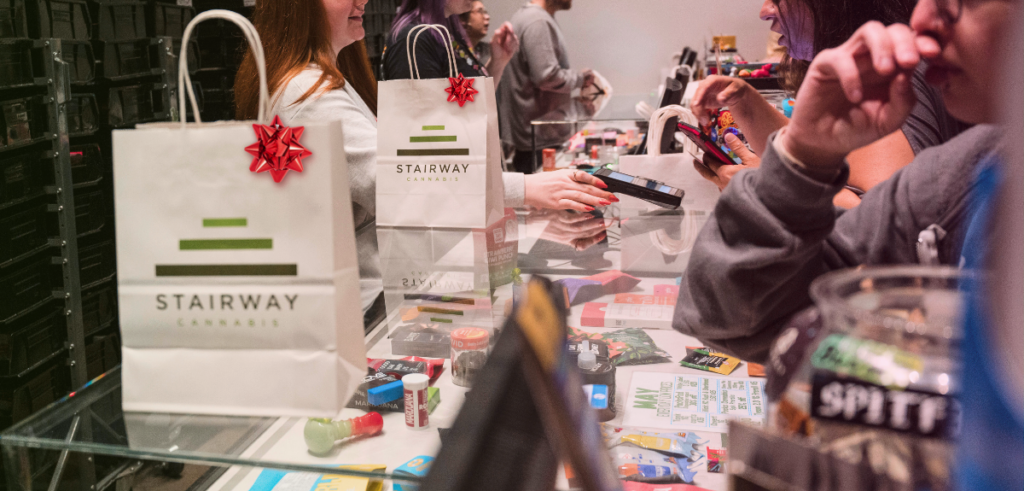 Customers purchase their marijuana at the sales counter from budtenders at Stairway Cannabis. The exit bags have red gift bows on them.