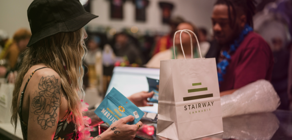 Budtender, Kate, explains a cannabis label to a customer.