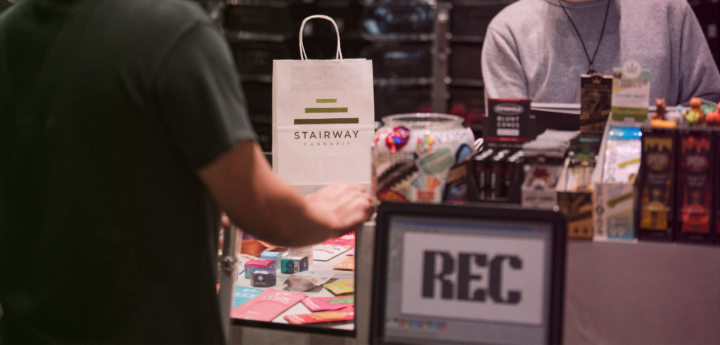 A customer stands in the recreational line at Stairway Cannabis making a purchase. 