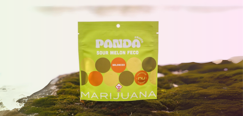 A bag of Panda Sour Melon Feco gummies sits on a mossy outdoor surface.