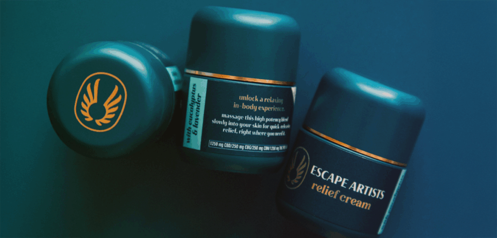 Close-up of Escape Artists cannabis-infused relief creams with sleek packaging and calming tones.