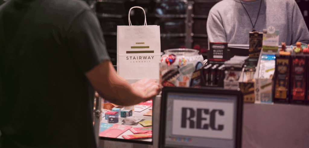 A customer stands in the recreational line at Stairway Cannabis making a purchase.